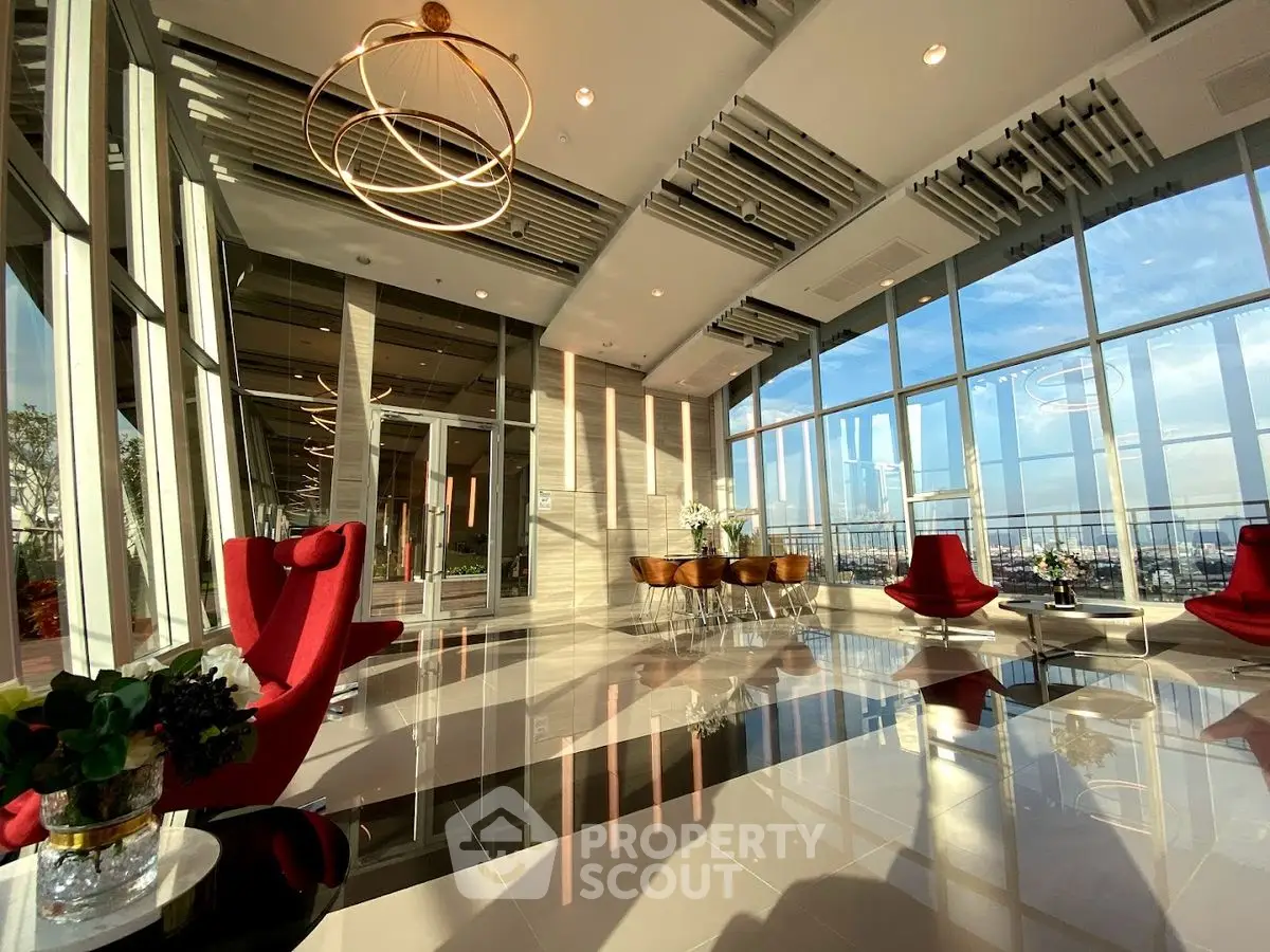 Luxurious modern living room with panoramic city view and elegant red chairs
