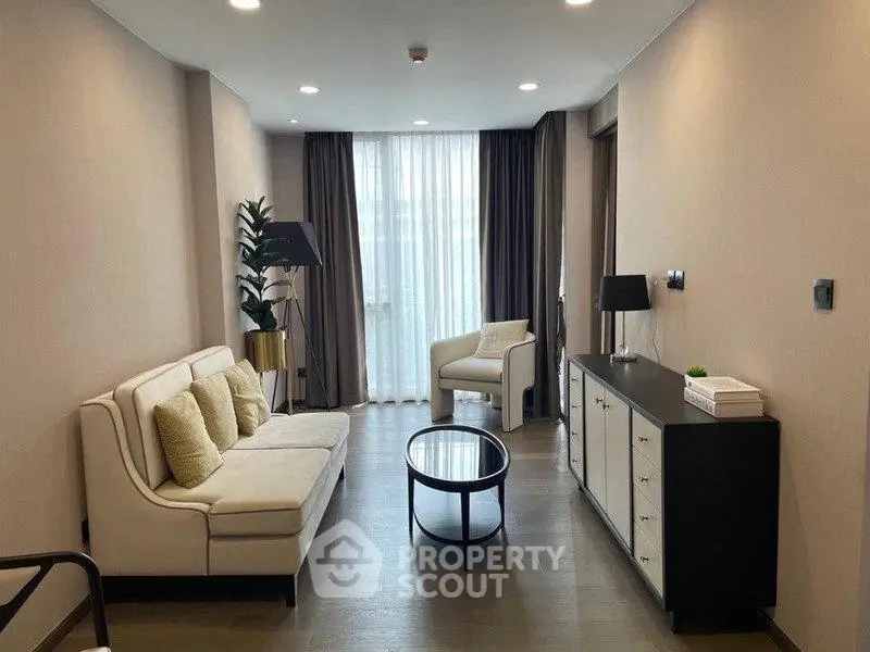 Elegant living room with modern furniture and natural light, perfect for relaxation and entertaining.