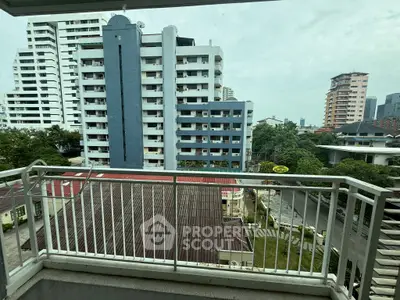 Spacious balcony with city view in modern apartment building