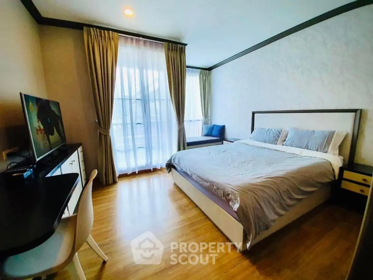 Spacious bedroom with modern decor and natural light