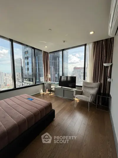 Luxurious bedroom with floor-to-ceiling windows offering stunning city views in a modern high-rise.