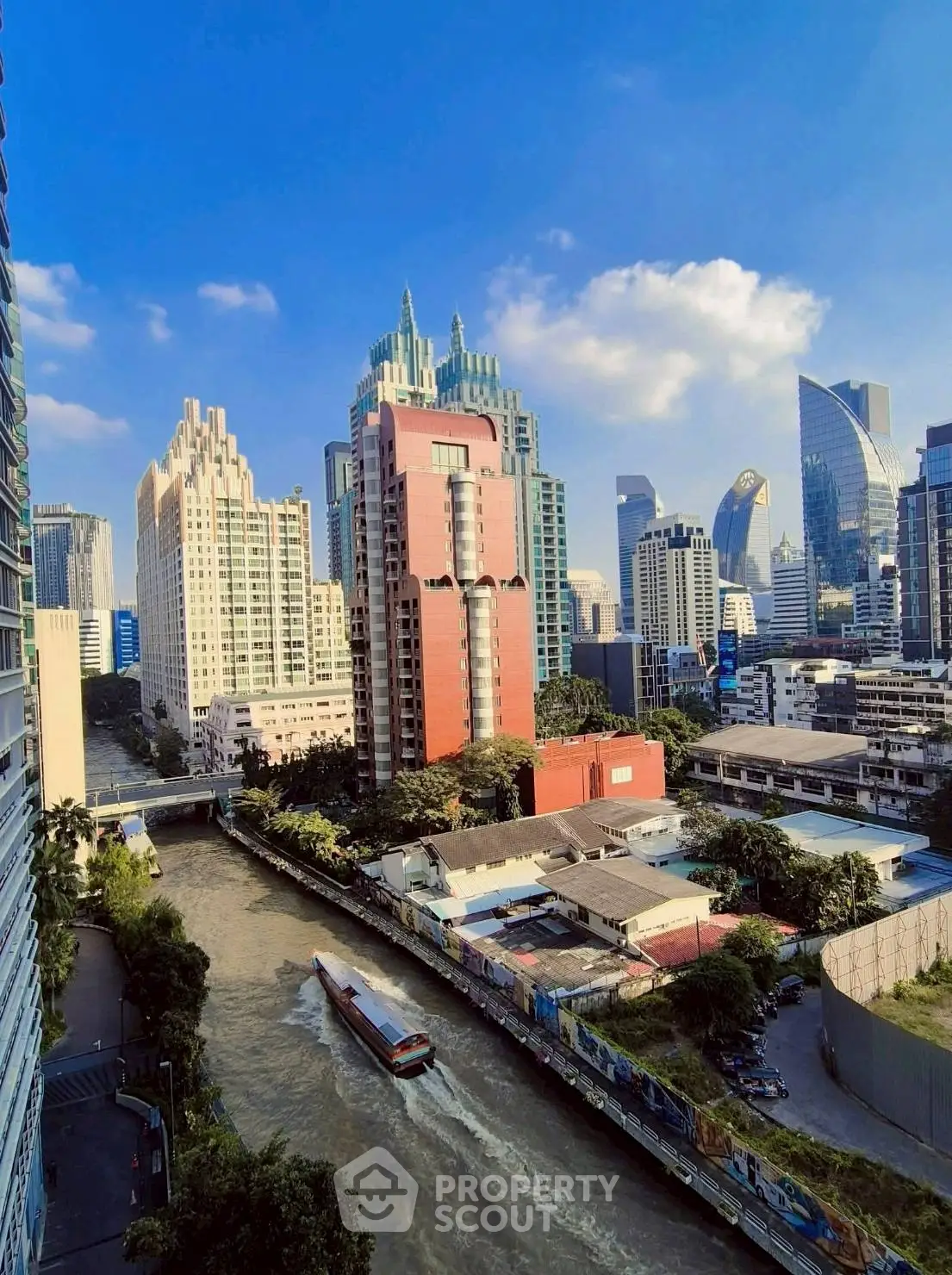 Stunning cityscape view with modern skyscrapers and a serene river, perfect for urban living enthusiasts.