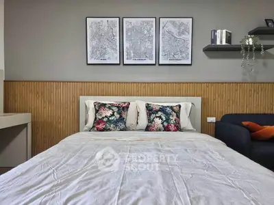 Cozy bedroom with stylish decor and floral cushions, perfect for relaxation and comfort.