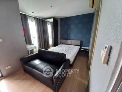 Modern bedroom with stylish decor and cozy furnishings in a well-lit apartment.