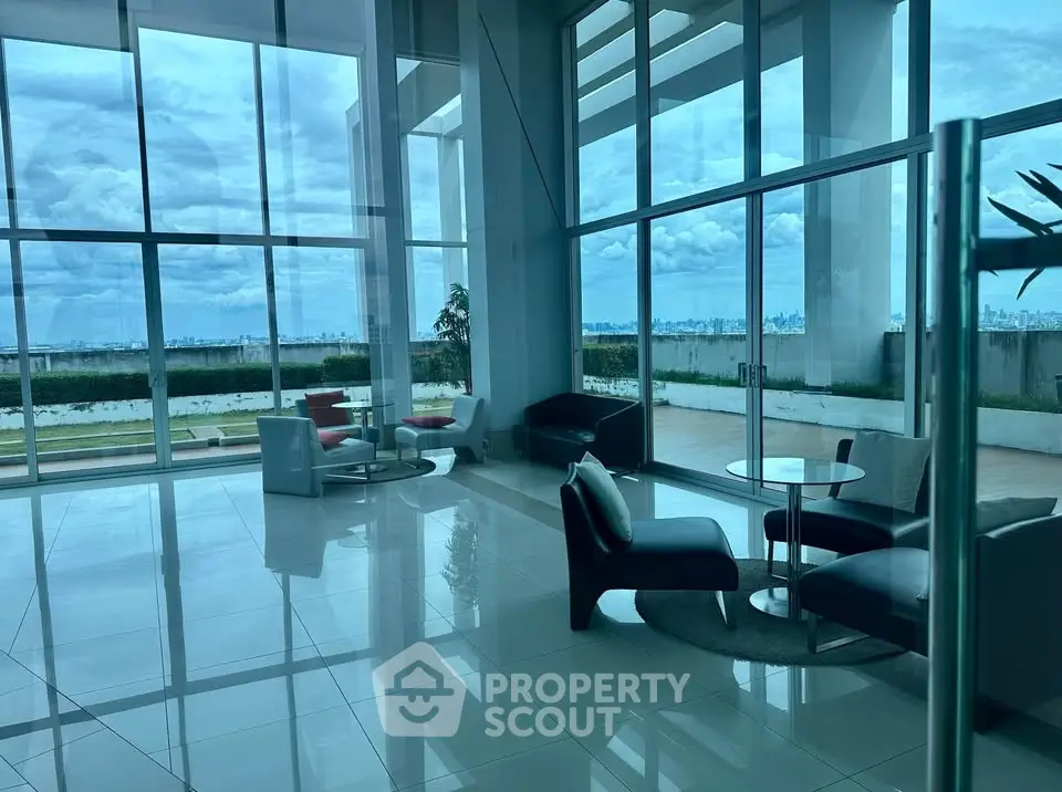 Luxurious modern living room with panoramic city views and elegant furnishings.