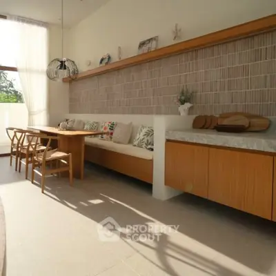 Elegant dining area with natural light and stylish wooden furniture