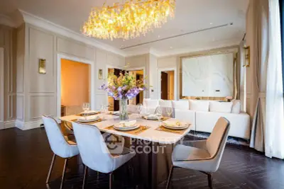 Luxurious dining and living area with elegant chandelier and modern decor