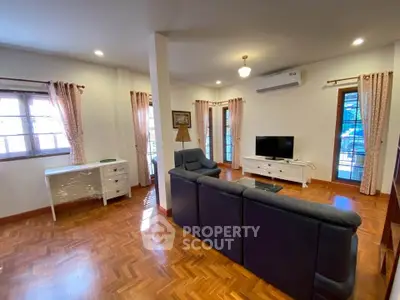 Spacious living room with elegant parquet flooring and modern furnishings