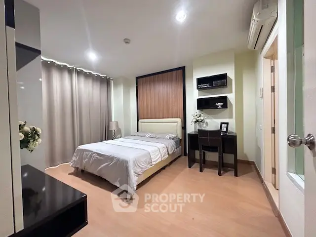 Modern bedroom with elegant decor and cozy ambiance, featuring a comfortable bed and stylish furnishings.