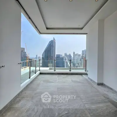 Spacious balcony with stunning city skyline view in modern high-rise apartment.
