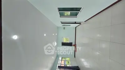 Spacious empty living room with large windows and modern lighting