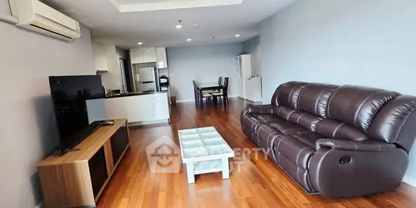 Spacious living room with modern furniture and open kitchen layout