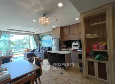 Spacious open-layout living room with modern kitchen and scenic balcony view