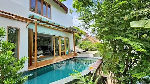 Luxurious villa with private pool and lush greenery, perfect for serene living.