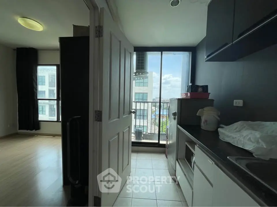Modern apartment kitchen with balcony view and sleek design