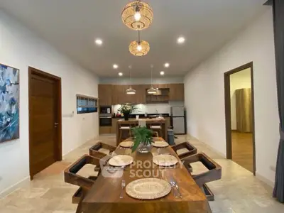 Spacious dining area with elegant wooden table and modern kitchen in open layout