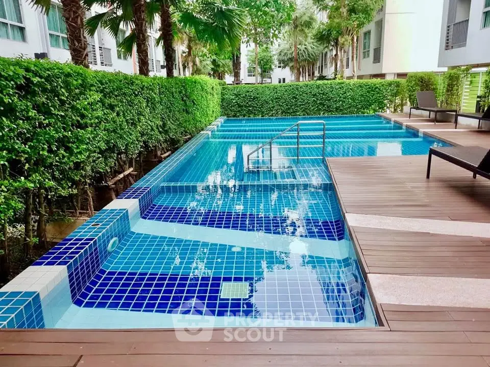 Luxurious outdoor pool with modern design and lush greenery