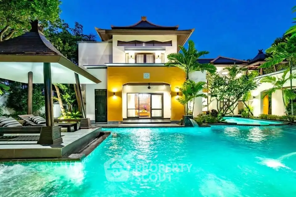 Luxurious villa with stunning pool and tropical garden at dusk