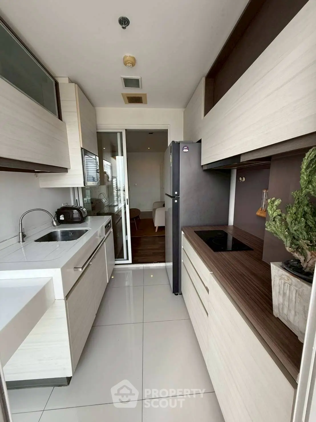 Modern kitchen with sleek cabinetry and appliances in a stylish apartment.
