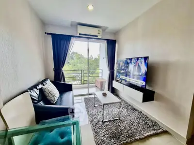 Modern living room with balcony view, sleek furniture, and large TV in a stylish apartment.