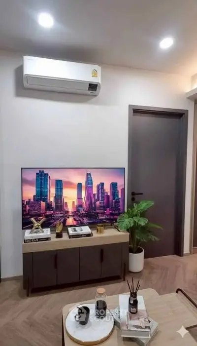 Modern living room with sleek furniture and wall-mounted TV, featuring stylish decor and ambient lighting.