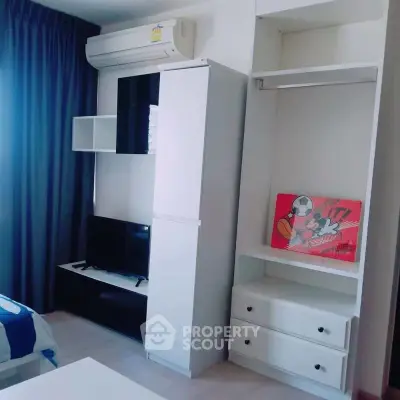 Modern bedroom with sleek furniture and air conditioning, perfect for comfortable living.