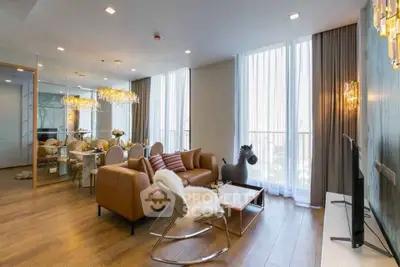 Luxurious modern living room with elegant decor and floor-to-ceiling windows in a high-end apartment.