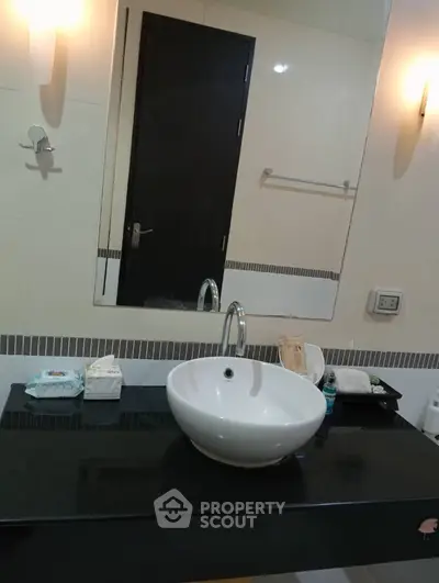 Modern bathroom with sleek sink and stylish lighting