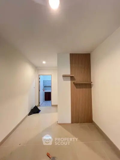 Modern minimalist interior with sleek tile flooring and wooden accent wall
