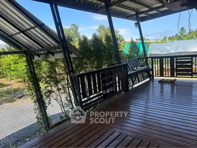 Charming wooden deck with lush garden view, perfect for outdoor relaxation and entertaining.