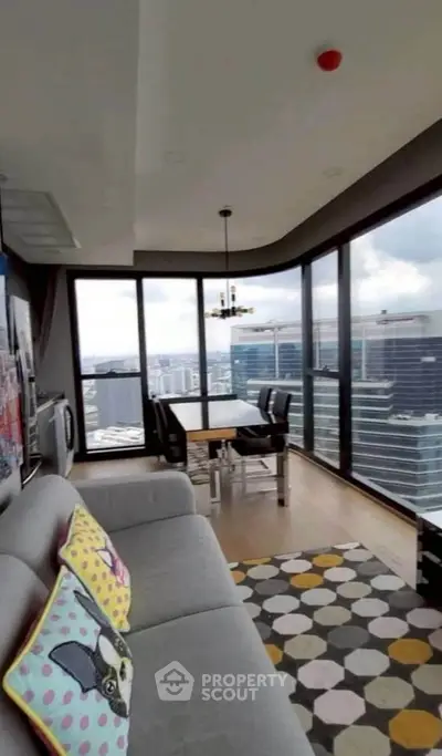 Stunning high-rise living room with panoramic city views and modern decor.