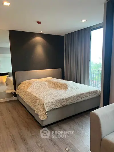 Modern bedroom with large window and stylish decor in a luxury apartment