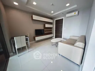 Modern living room with sleek furniture and wall-mounted TV in a stylish apartment.