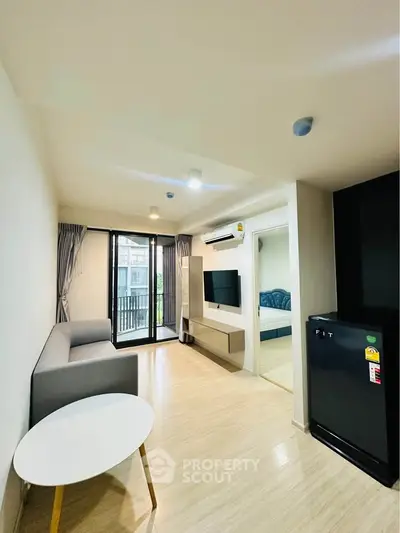 Modern living room with sleek furniture and balcony view in a stylish apartment.
