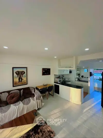 Spacious living room with open kitchen layout and modern decor