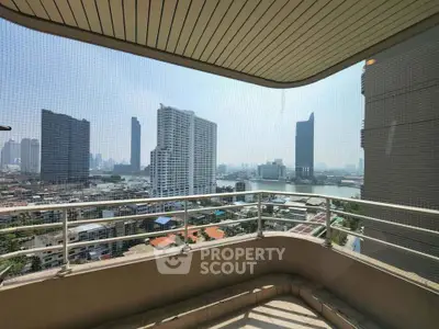 Stunning cityscape view from a spacious balcony in a high-rise building.
