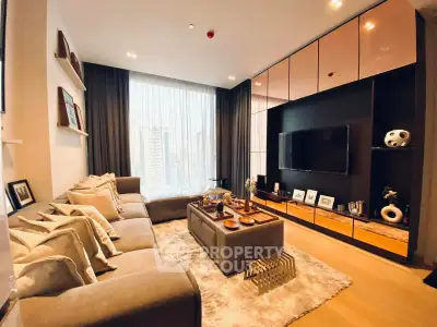 Luxurious living room with modern decor and city view, featuring plush seating and elegant shelving.