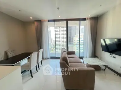 Modern living room with city view and elegant furnishings in high-rise apartment.