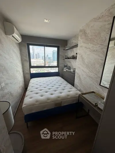 Modern bedroom with city view, featuring stylish decor and natural light.