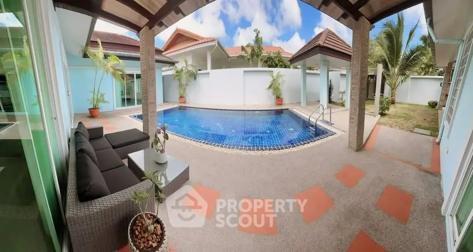 Luxurious villa with private pool and stylish outdoor seating area, perfect for relaxation and entertainment.