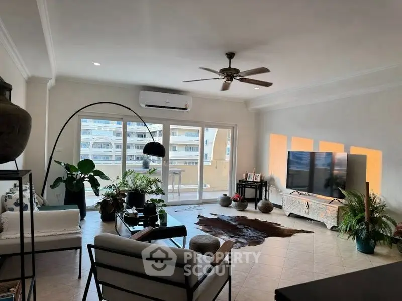 Spacious living room with modern decor and large windows for natural light.