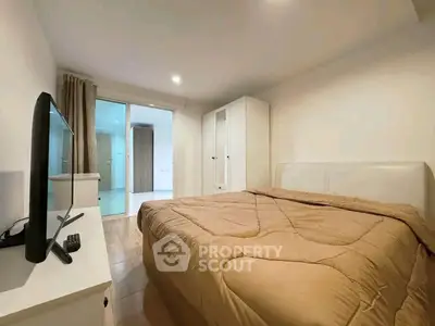 Cozy bedroom with modern furnishings and natural light, perfect for relaxation.