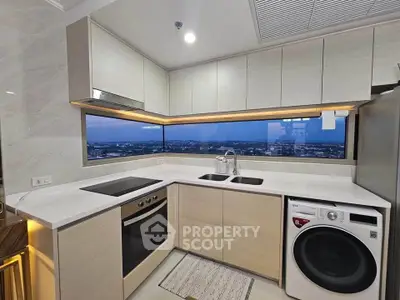 Modern kitchen with panoramic view, sleek cabinetry, and built-in appliances.