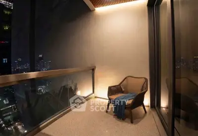 Luxurious balcony with stunning city skyline view at night, featuring cozy seating and ambient lighting.