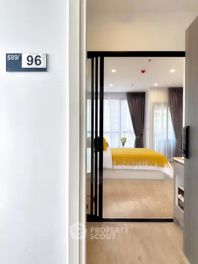 Modern bedroom with sliding glass door and stylish decor