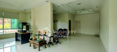 Spacious living room with elegant decor and large windows offering natural light.