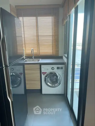 Modern kitchen with washing machine and sleek design