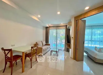 Spacious living room with modern decor and pool view, perfect for relaxation and entertaining.