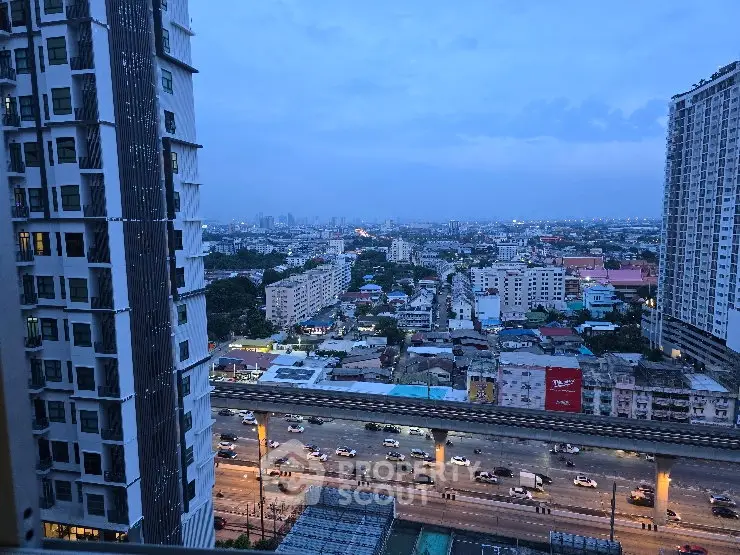 Stunning cityscape view from high-rise apartment with urban skyline and busy streets below.
