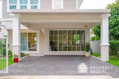 Modern house exterior with spacious carport and large windows